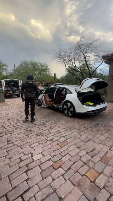 IGO mobile detailer arriving beside a white vehicle on a residential driveway