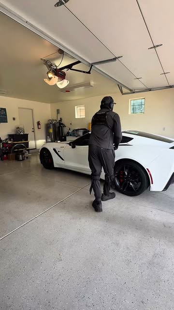 IGO mobile detailer beside a white sports car in a residential garage